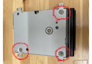 Three screws on the back of the disk drive